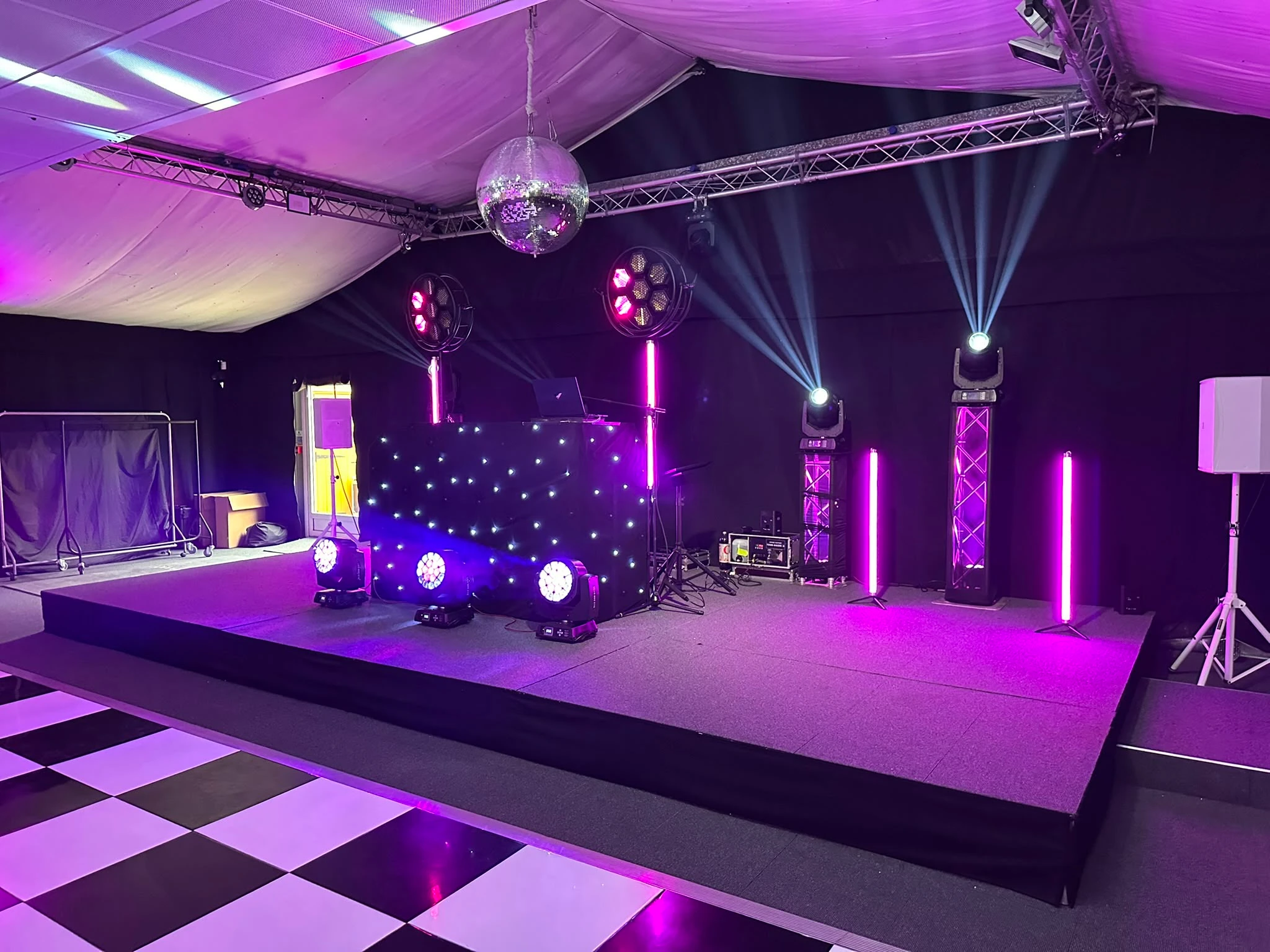 Truss, mirrorball and pink batons rigged in a marquee