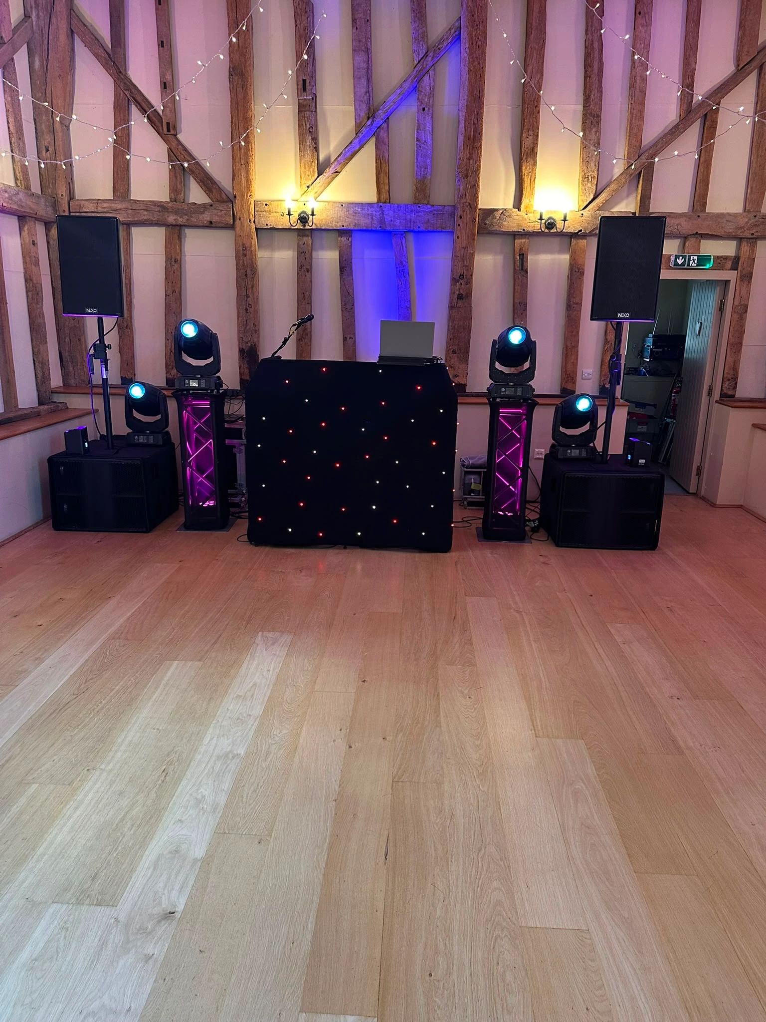 Black star booth and moving heads set up in a barn