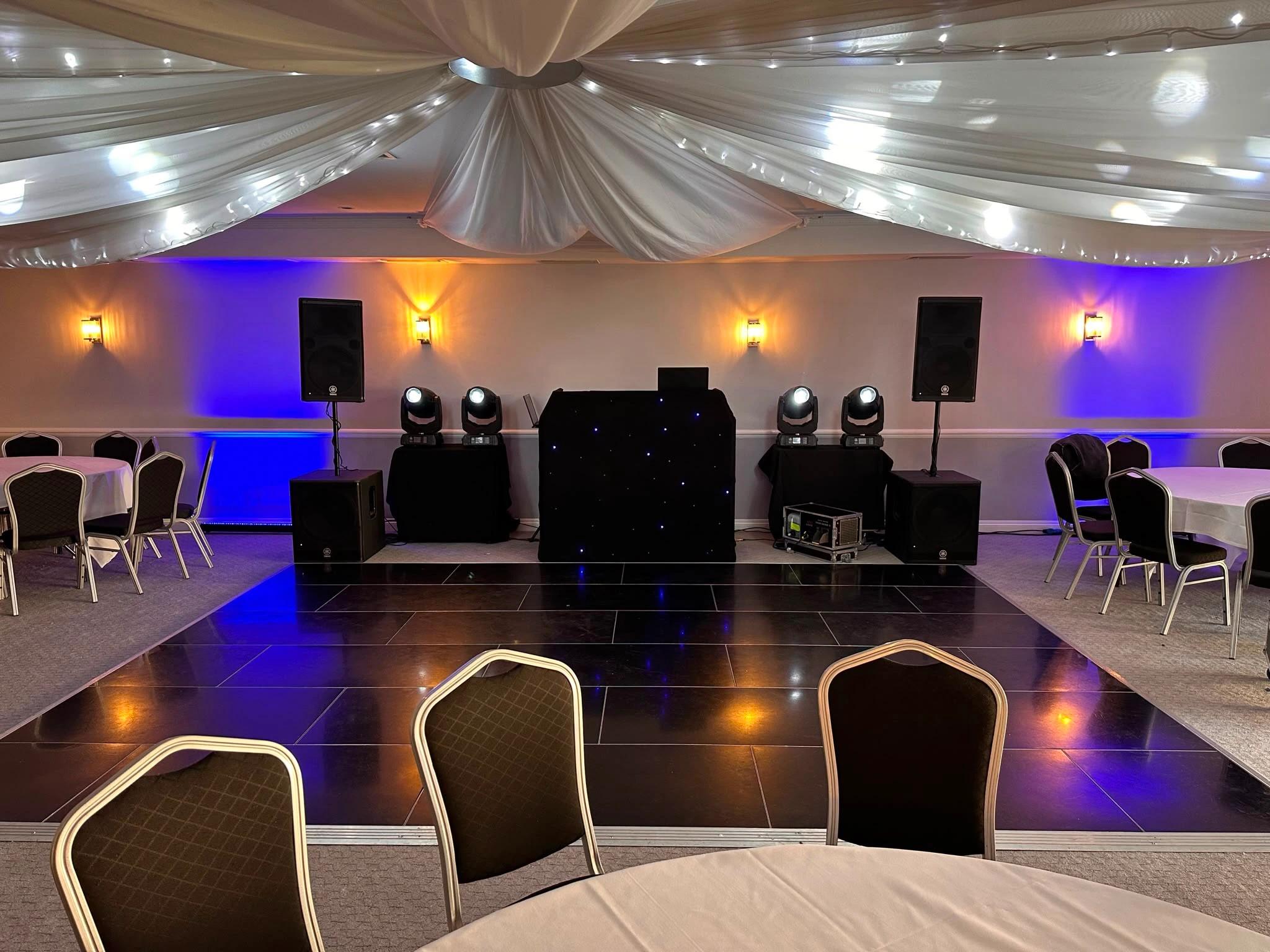 Black star booth beneath draped ceilings