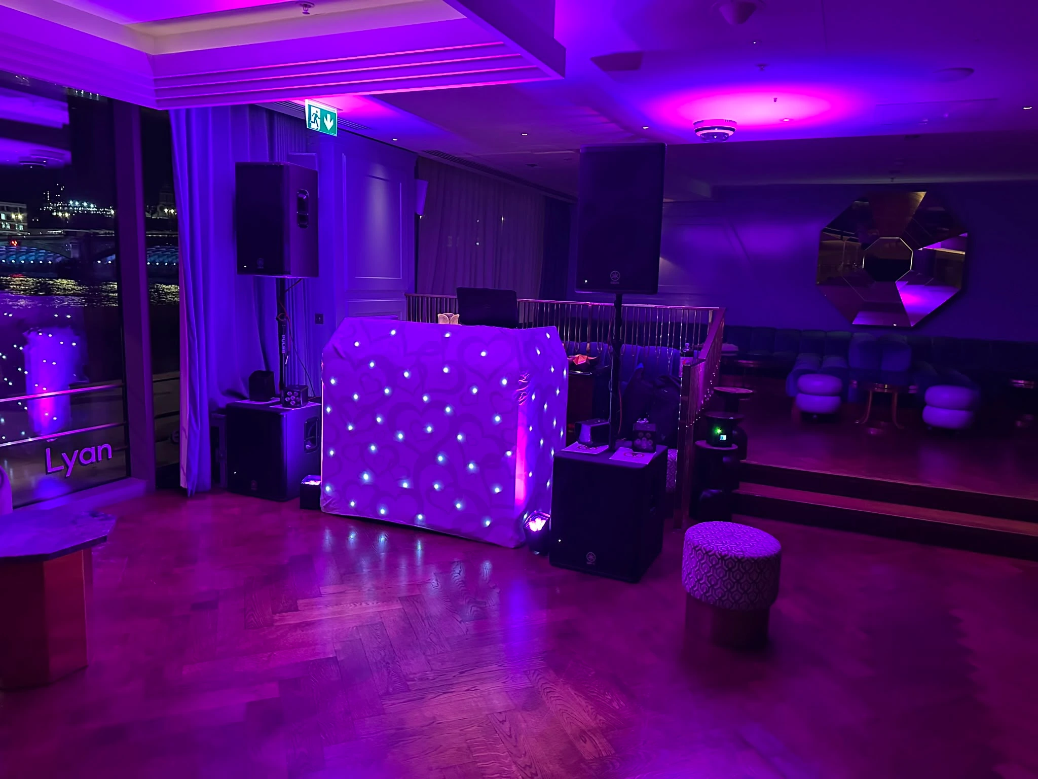 Star booth in a modern venue lit deep purple