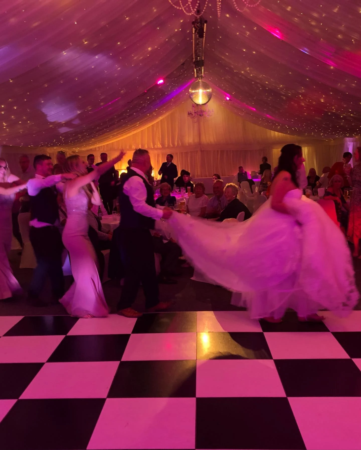 The bride's dress spinning out mid-first-dance in a marquee
