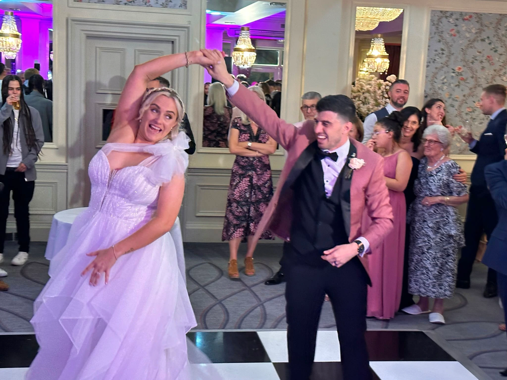 The bride spun under her groom's arm, both laughing