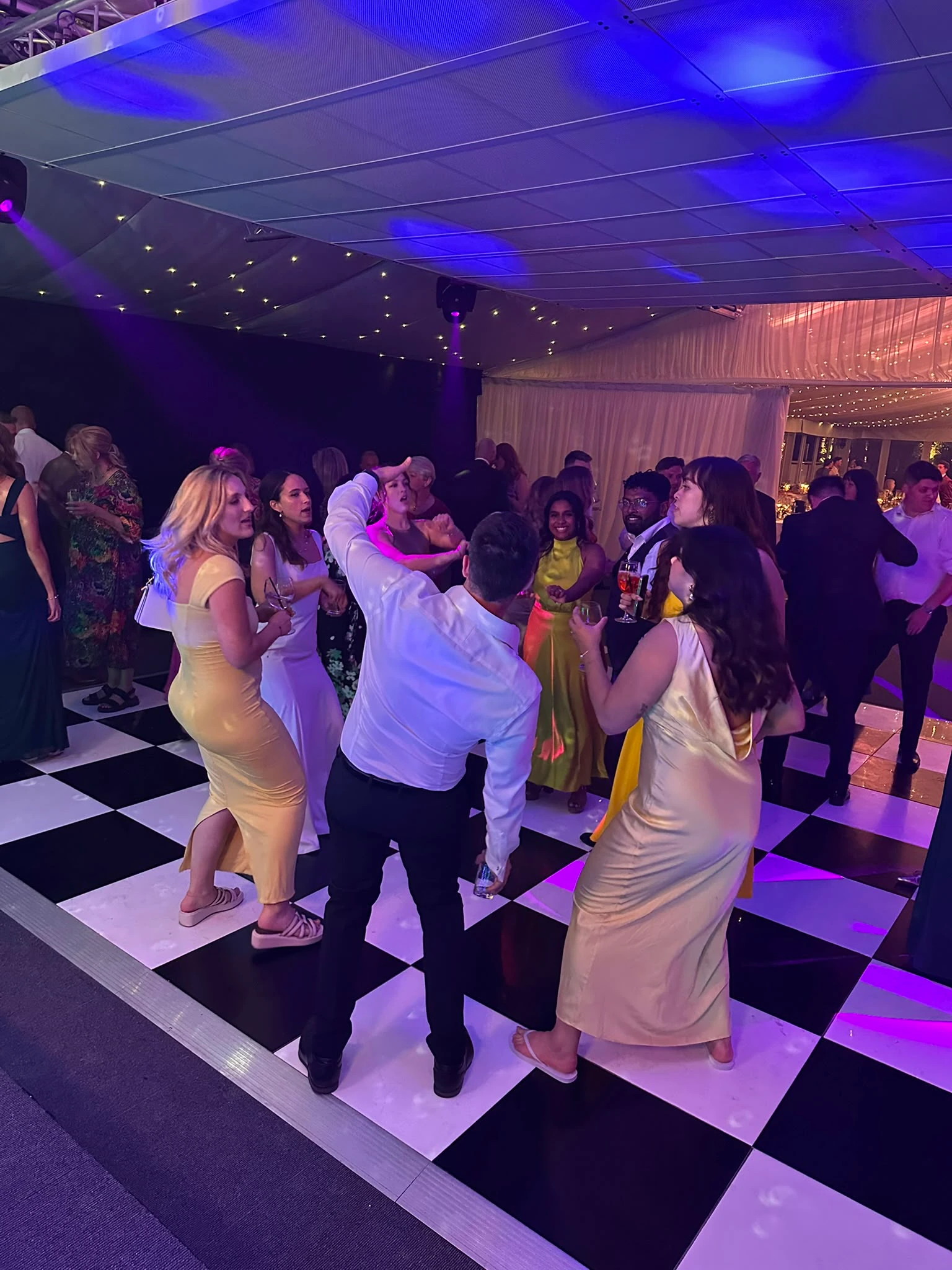 Guests filling a marquee dance floor