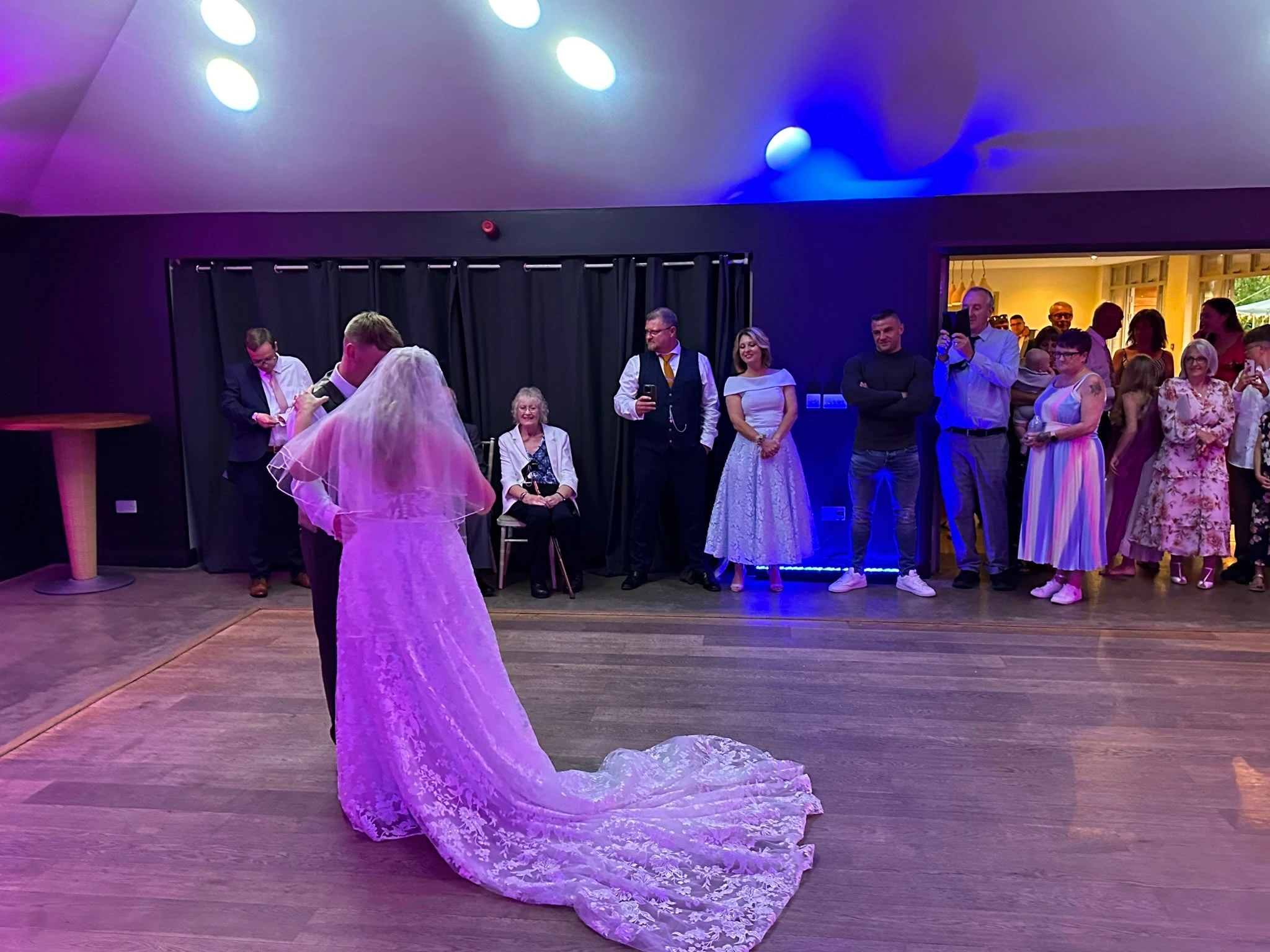 First dance in a modern venue, the veil trailing across the floor