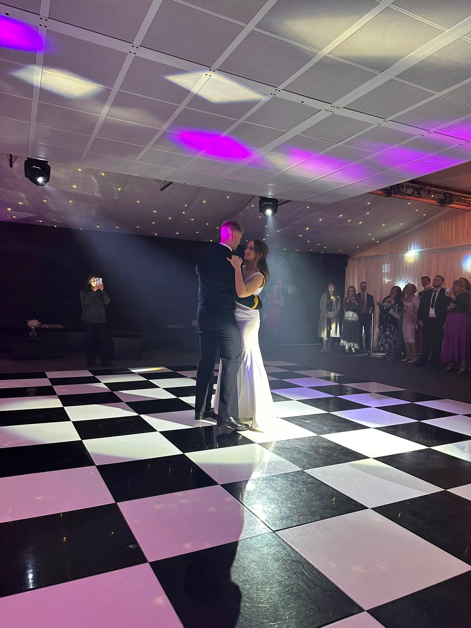 First dance in a spotlight on a checkerboard floor