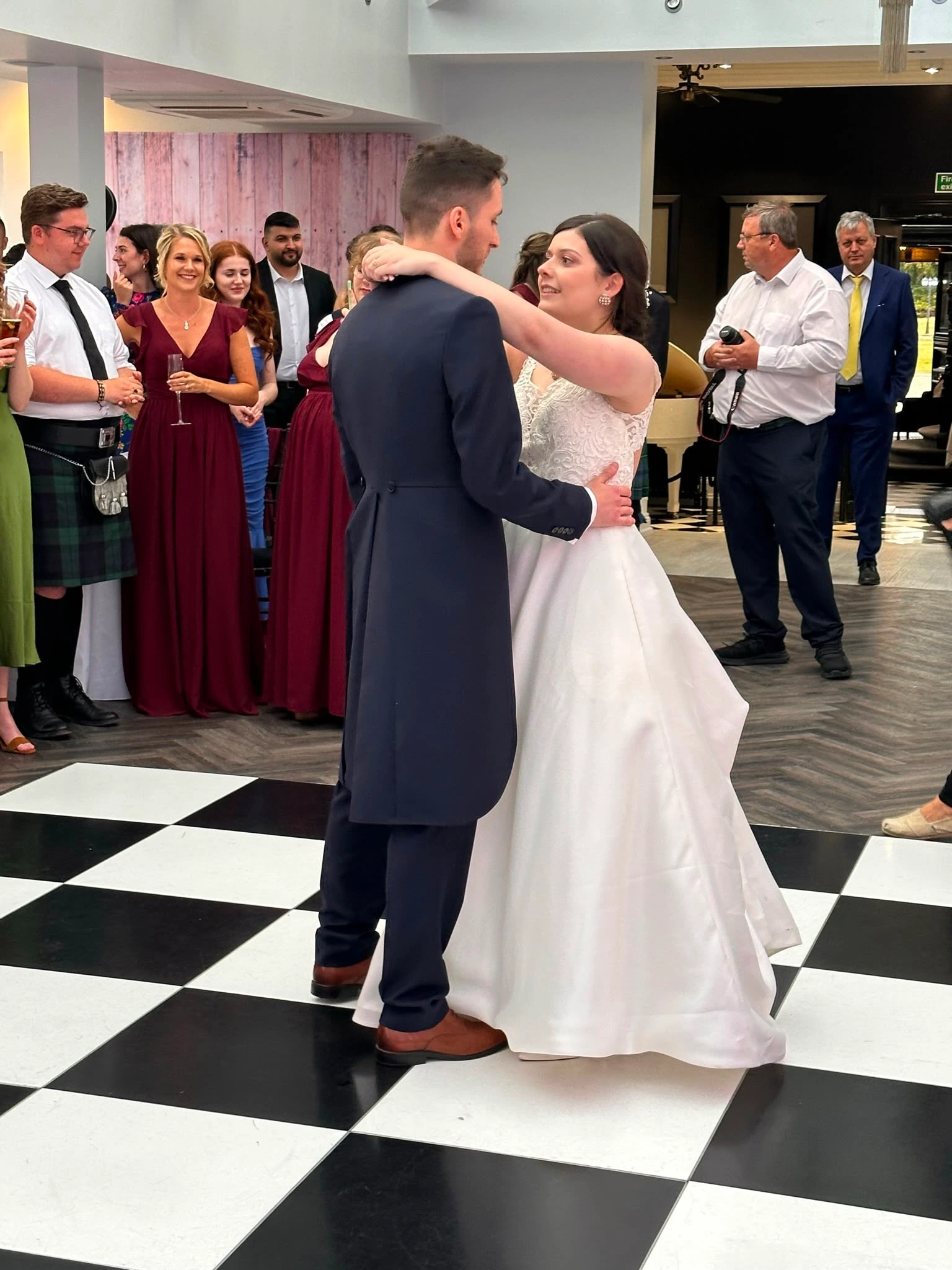 First dance surrounded by guests in kilts and black tie