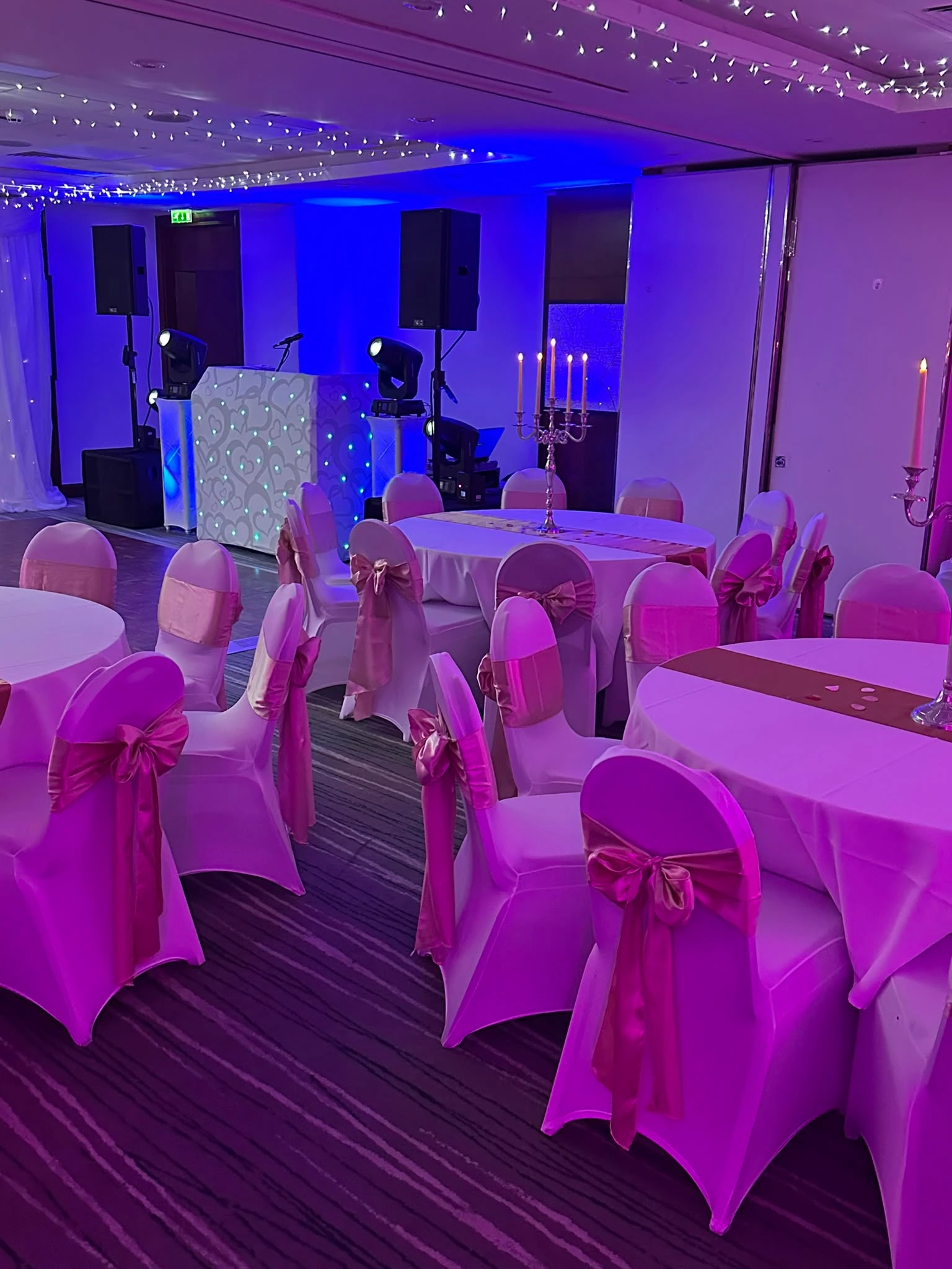 Pink-draped function room set for a party