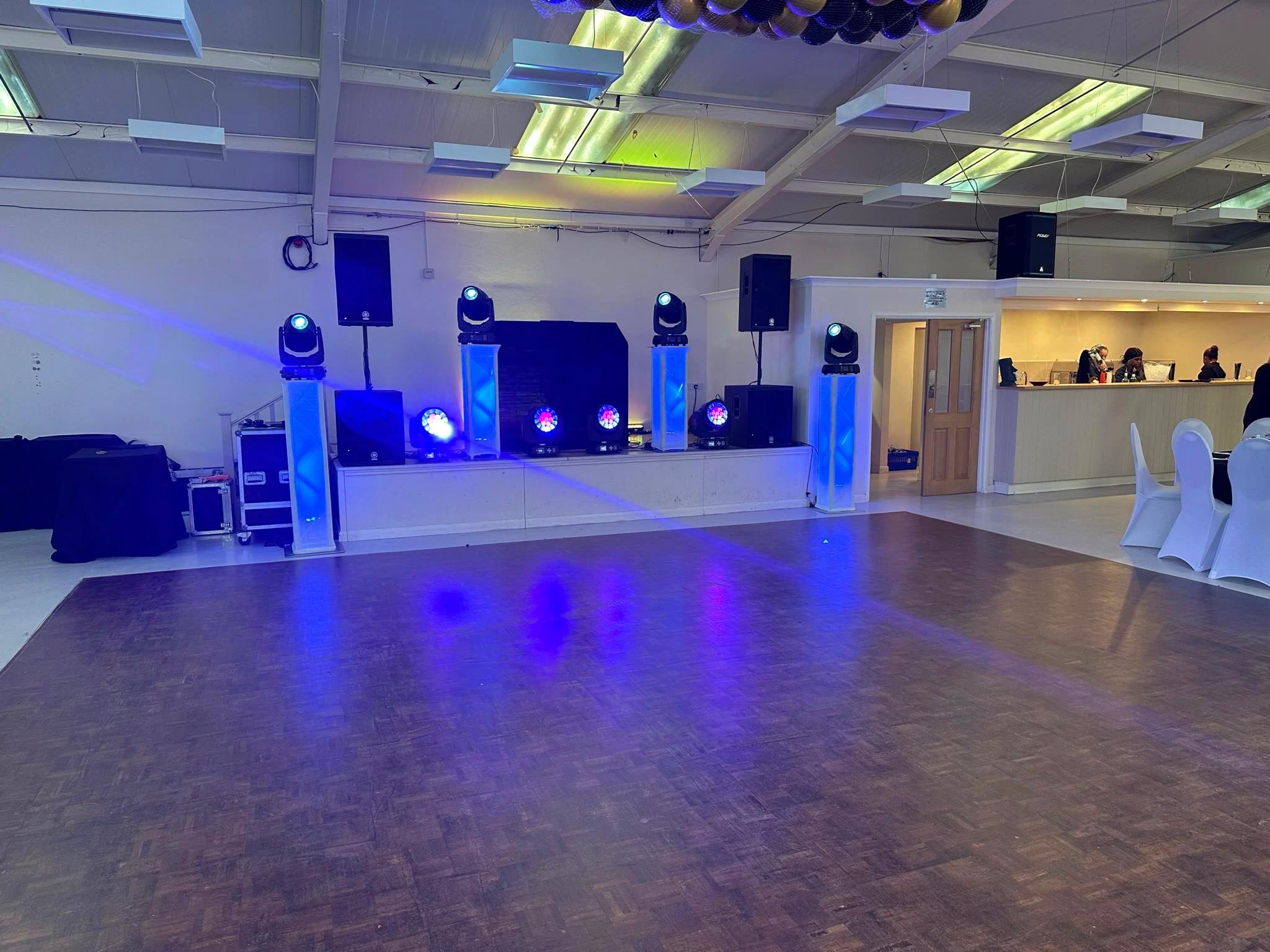 Blue-lit rig set up in a bright function room