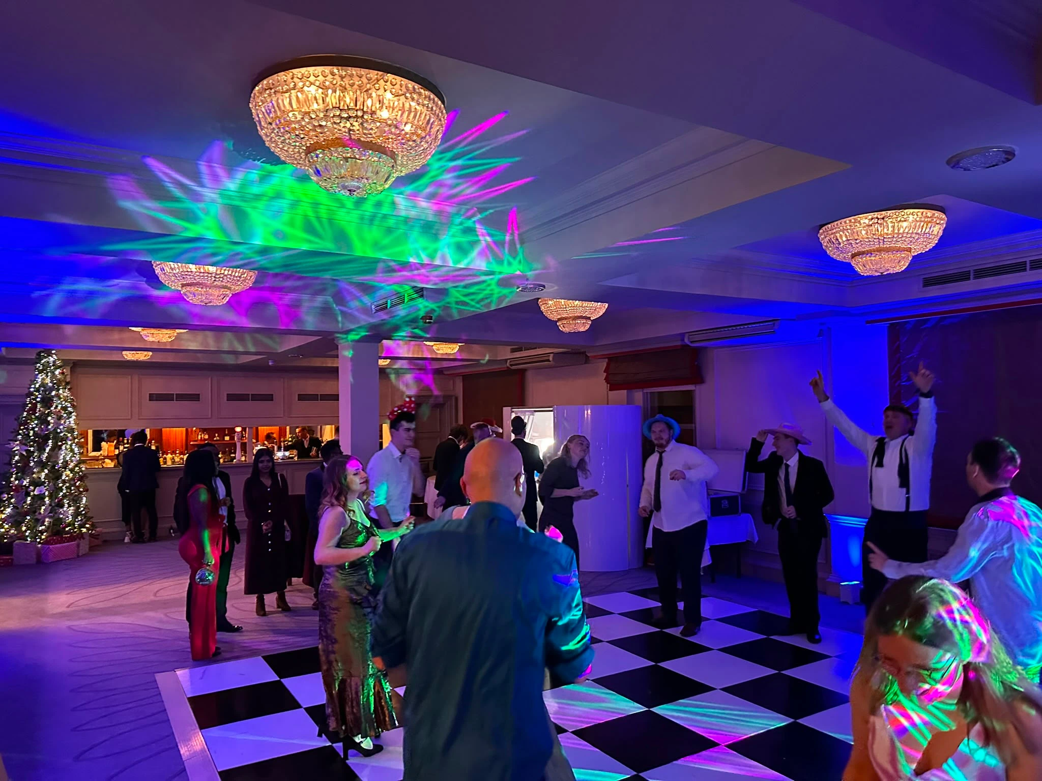 A Christmas party in full swing under the chandeliers