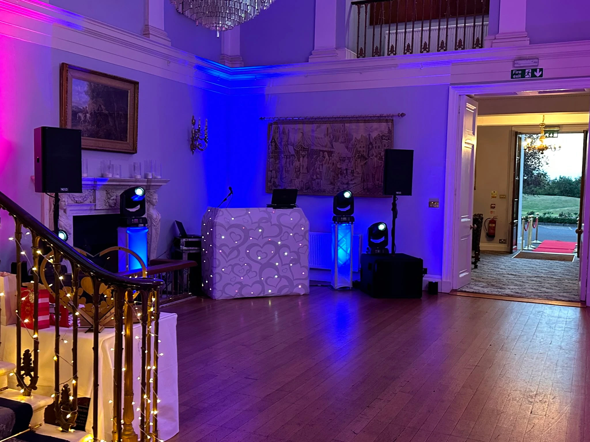 White heart booth and blue up-lighting in a manor hall