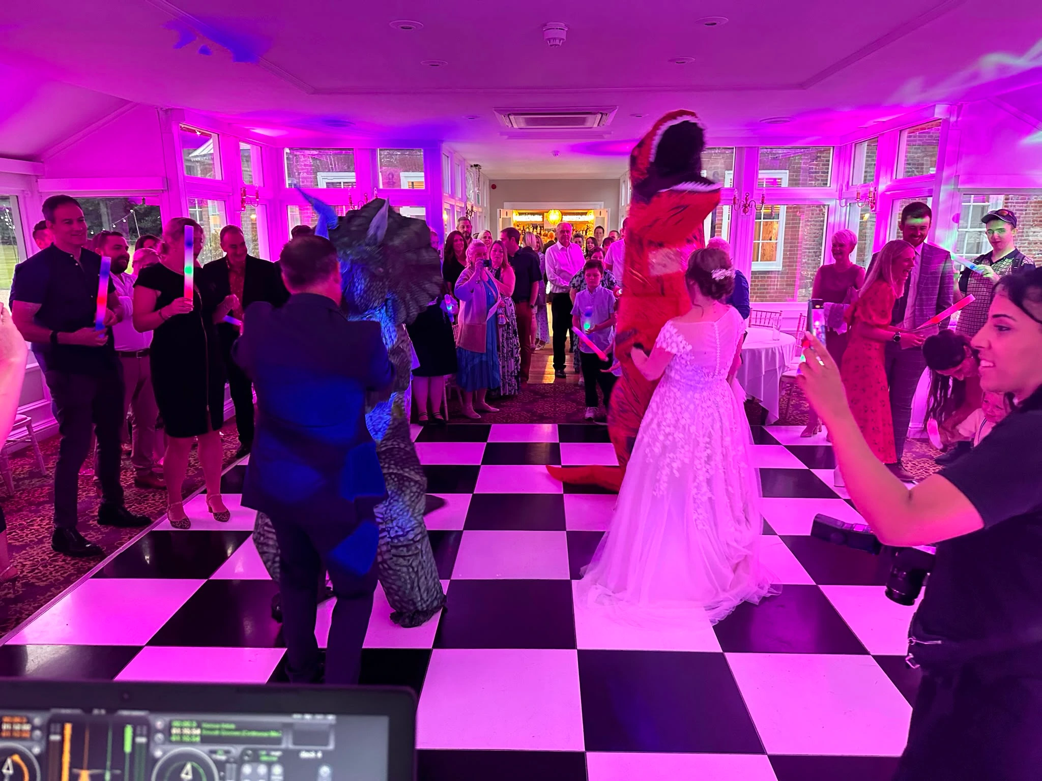 Guests in dinosaur costumes taking over the dance floor