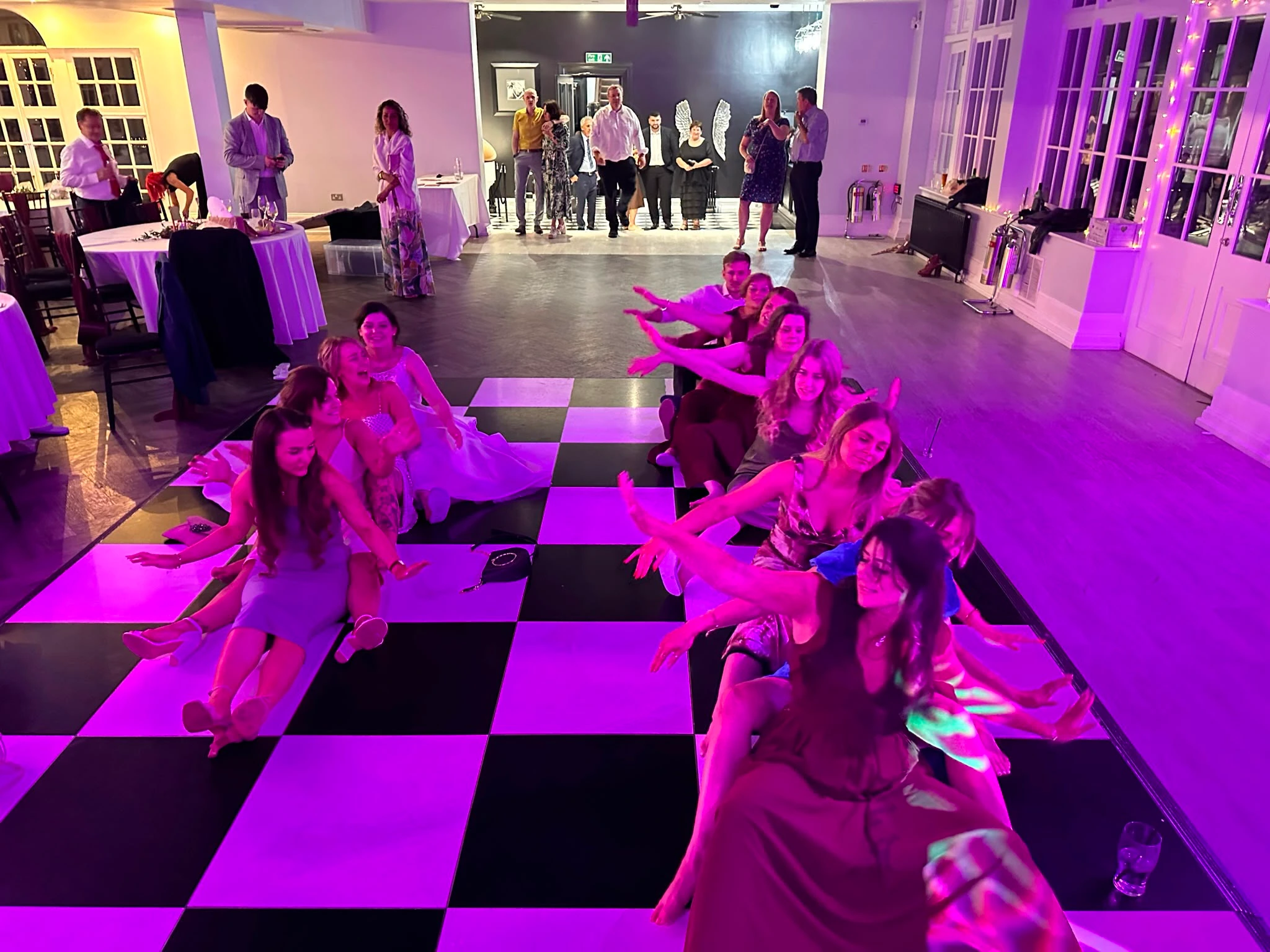 Guests sat on the floor doing the rowing-boat routine