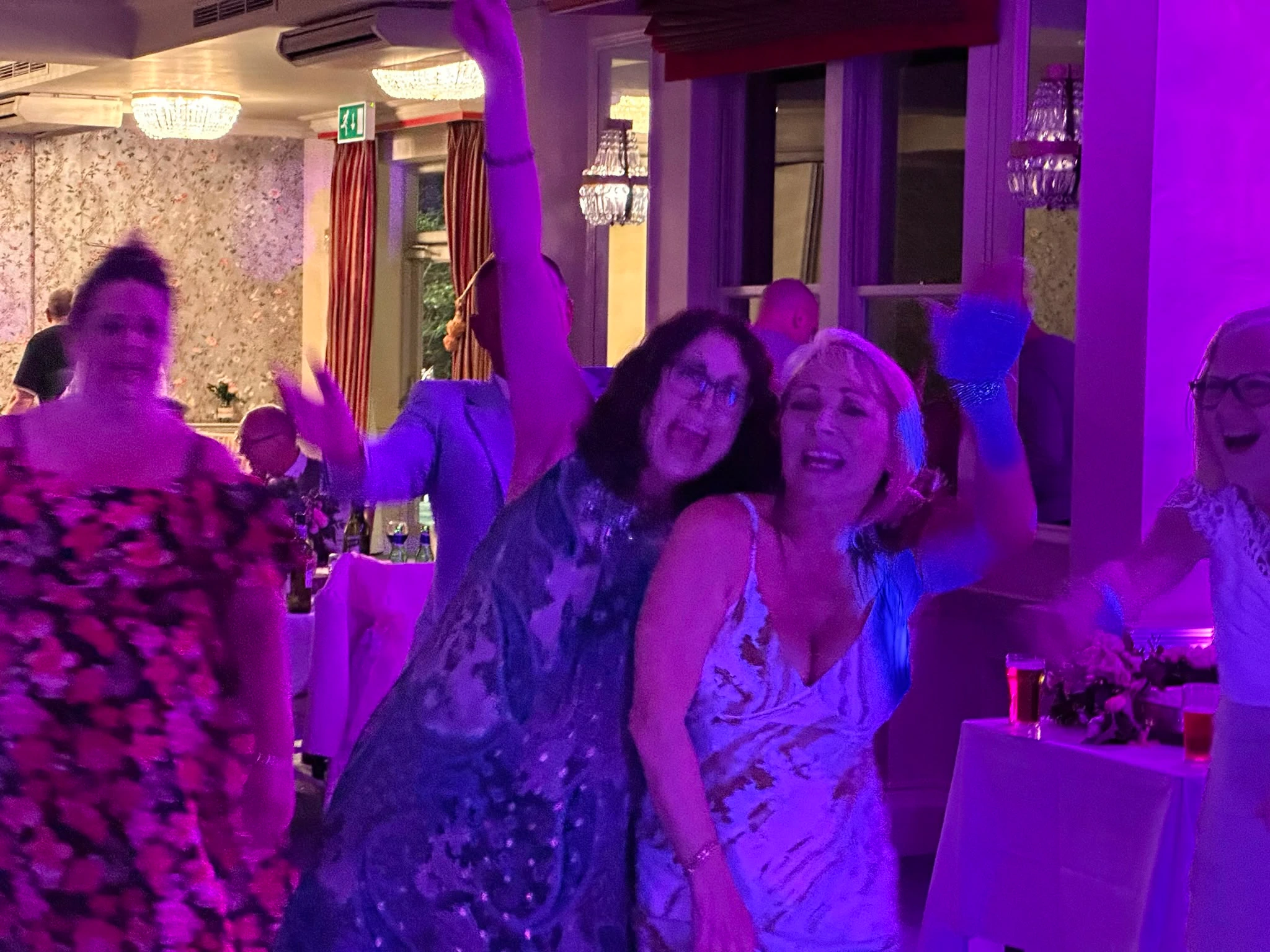 Two guests caught mid-laugh on the dance floor