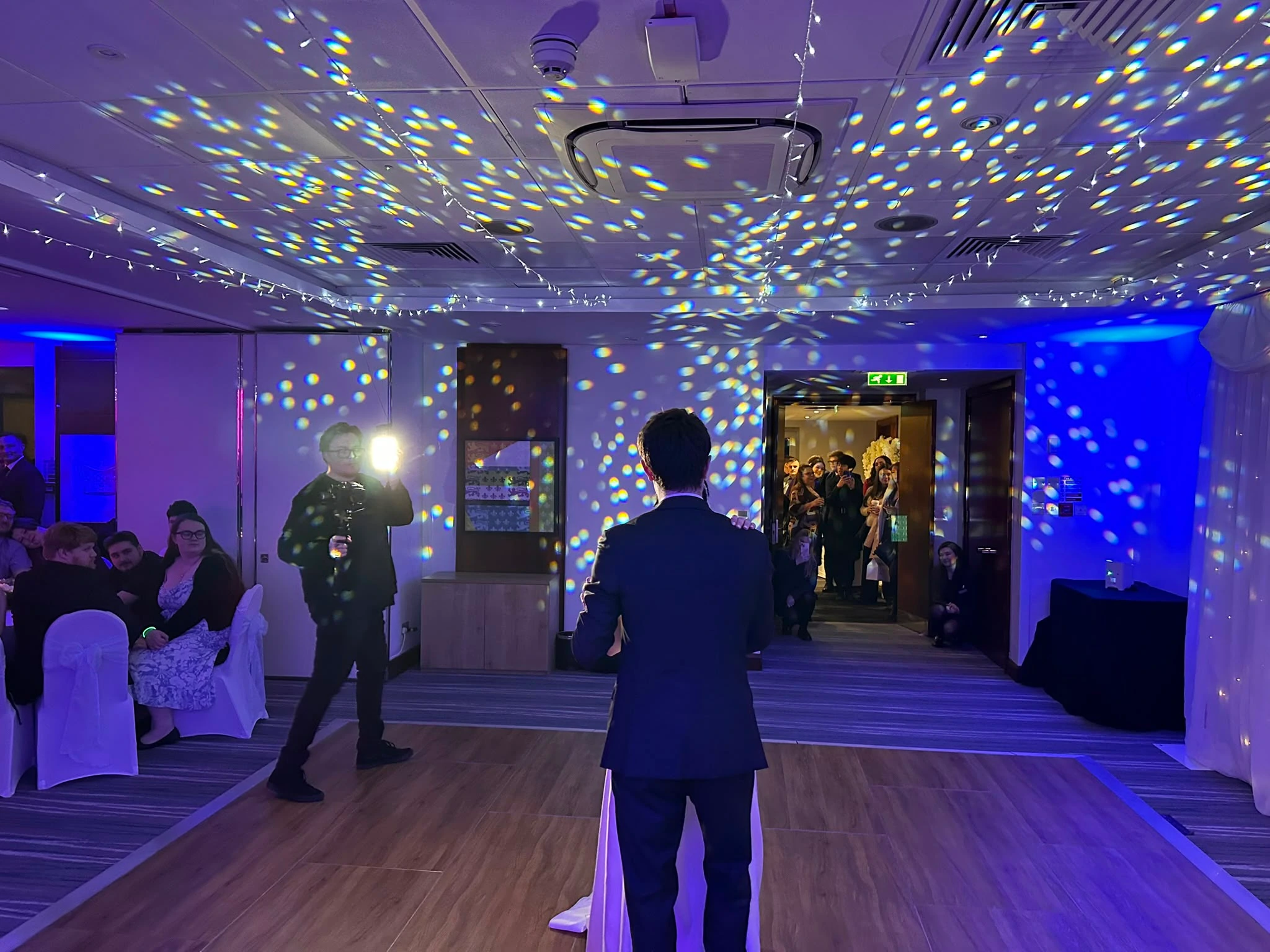 The groom's speech under a ceiling of drifting light