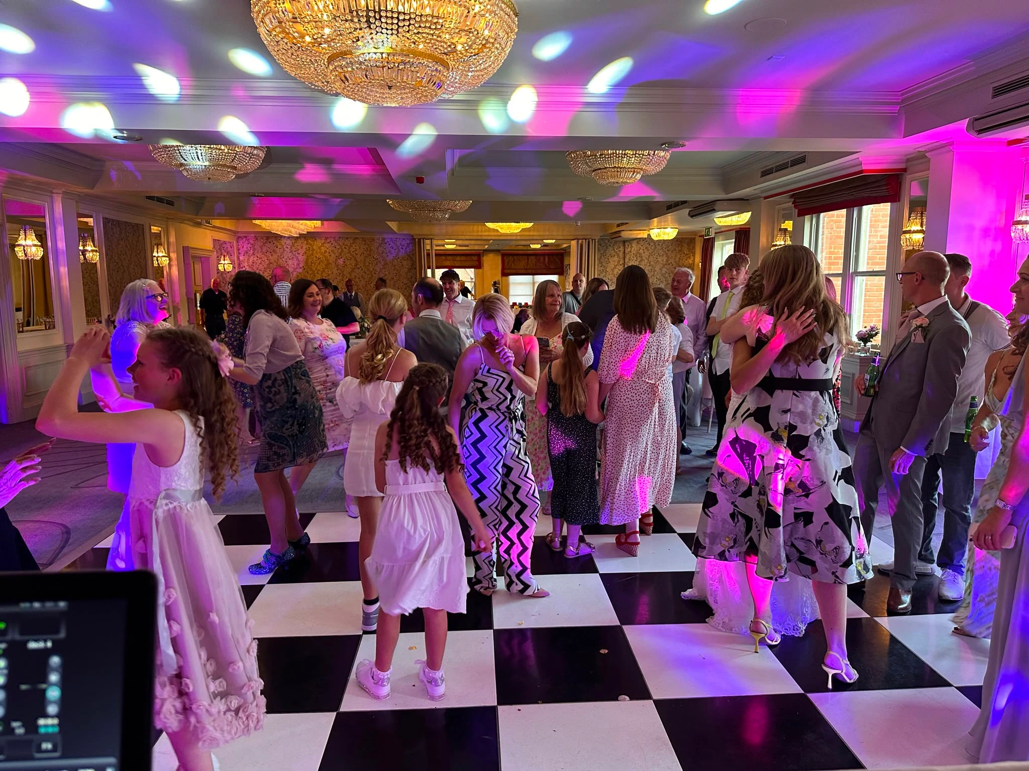 Three generations dancing together on the checkerboard