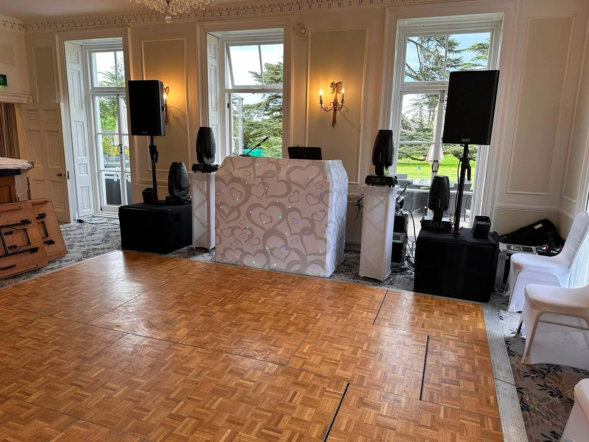 White booth and podiums set up in a daylit manor room