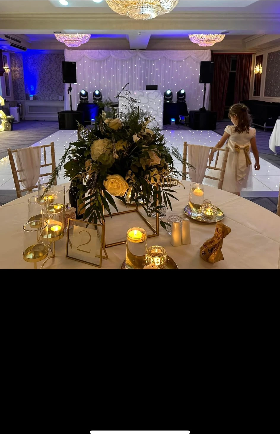 Candlelit table with the booth glowing behind it