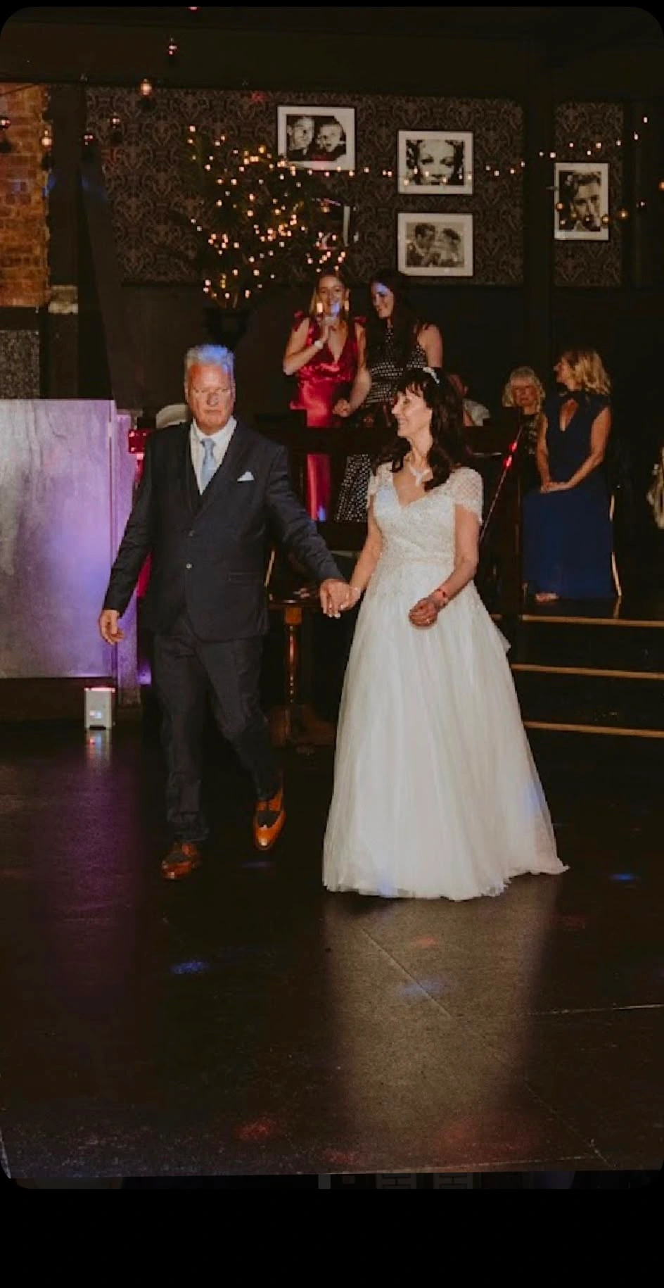 The bride walking in with her father to a waiting room