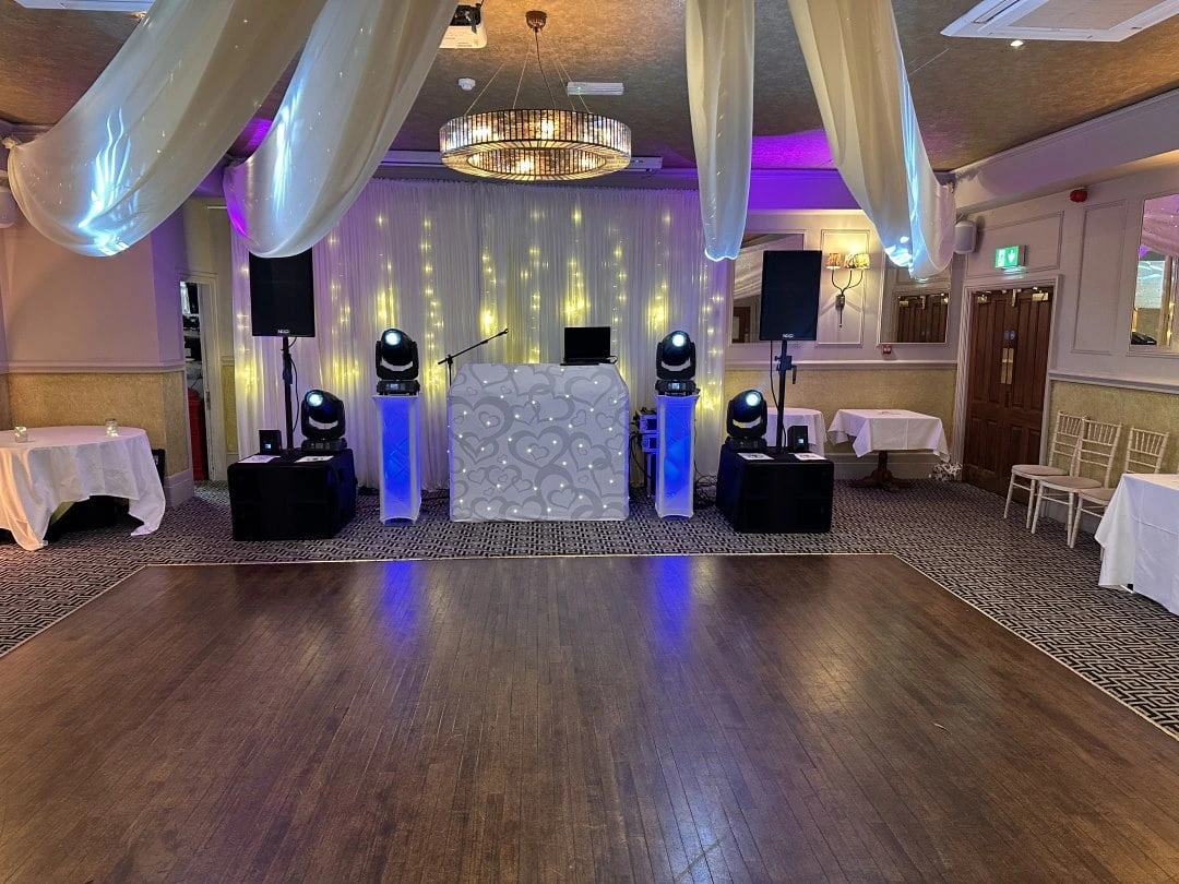 White booth and up-lighting in a draped function room
