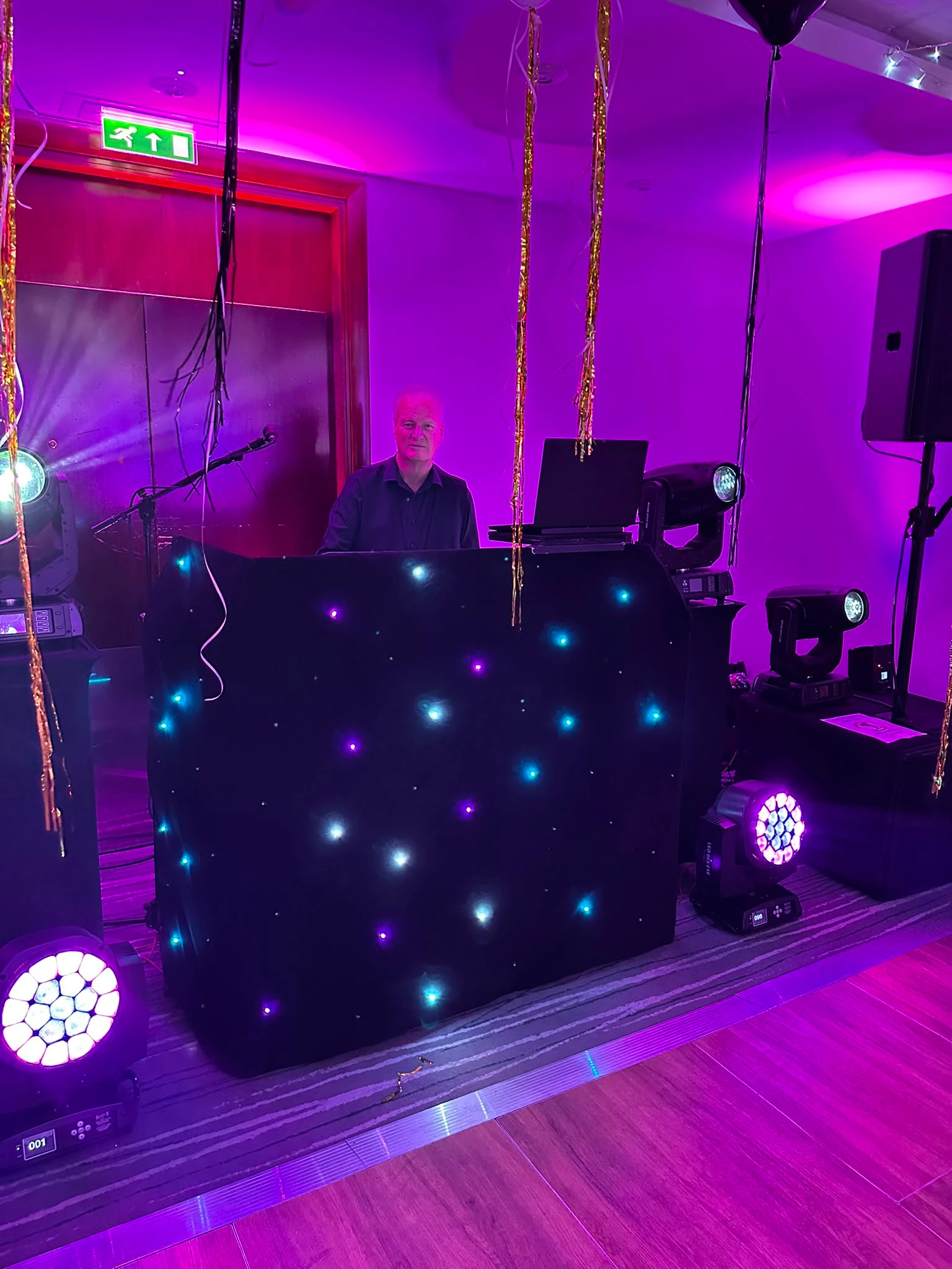 Chris behind the decks at a black star booth