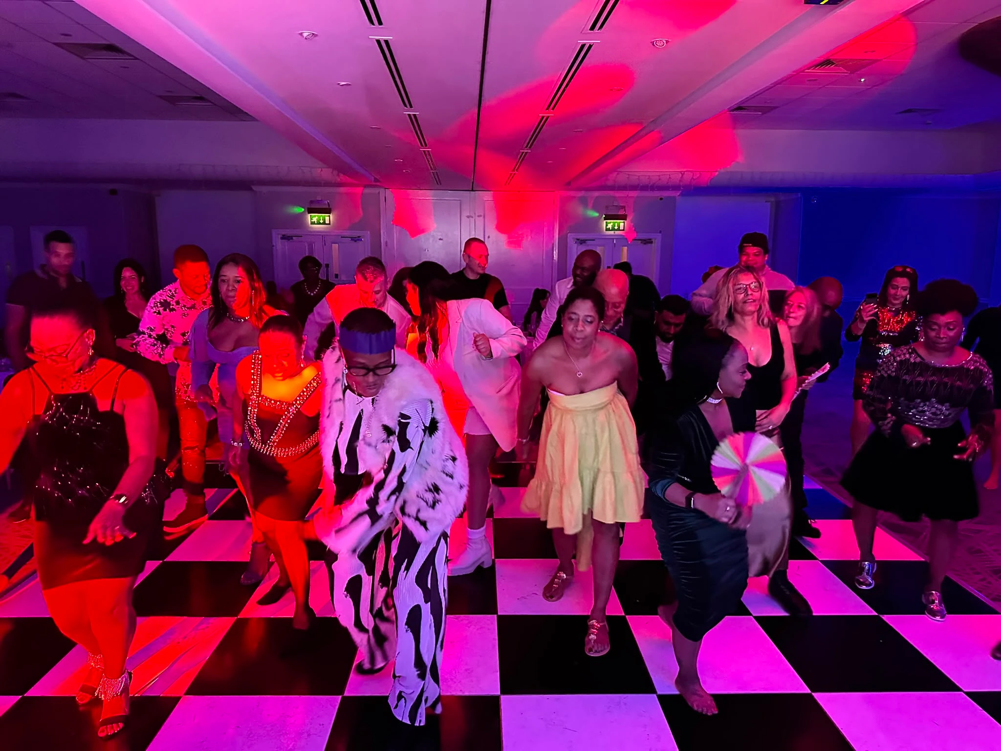 A dance floor washed red and pink
