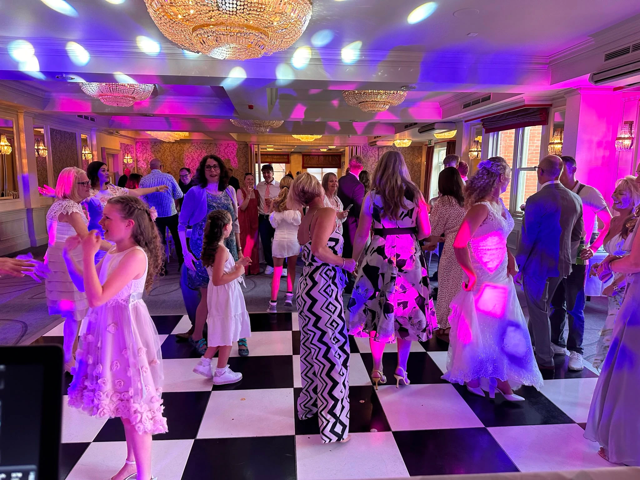 Families dancing together on the checkerboard