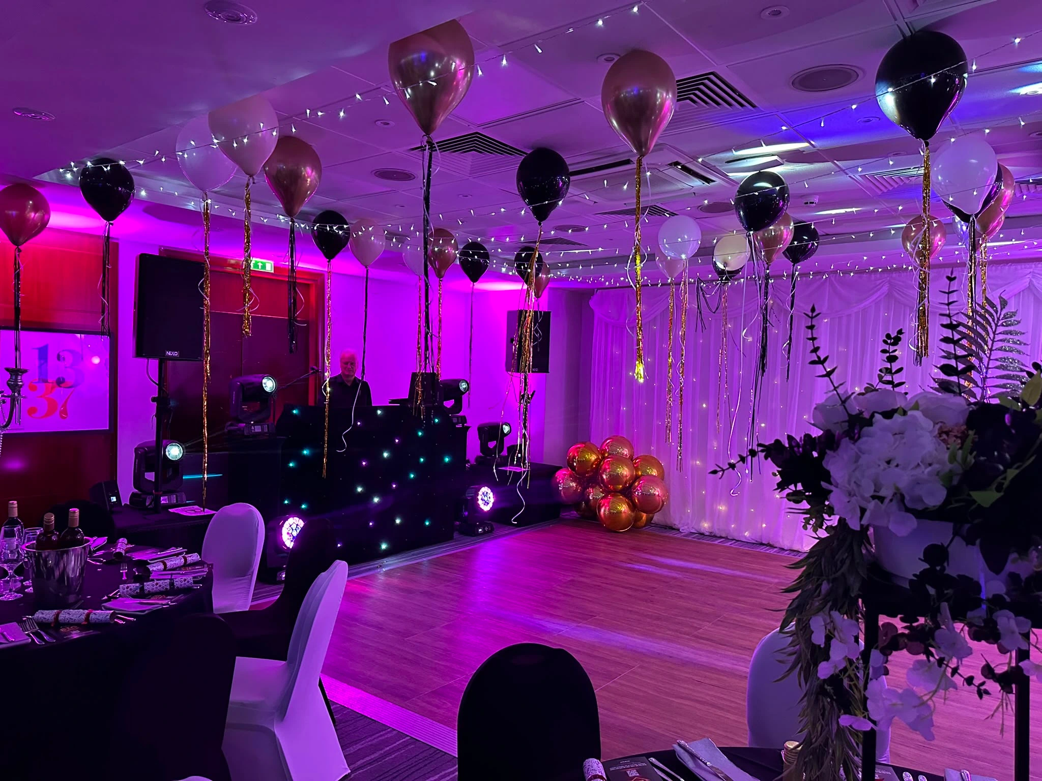 Star booth framed by balloons and light beams