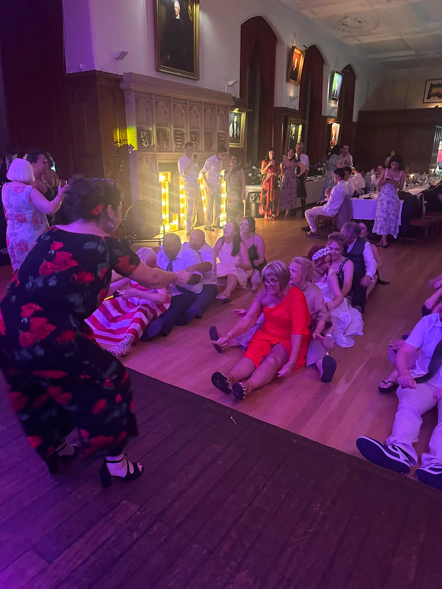The whole room sat down for a floor game late in the evening