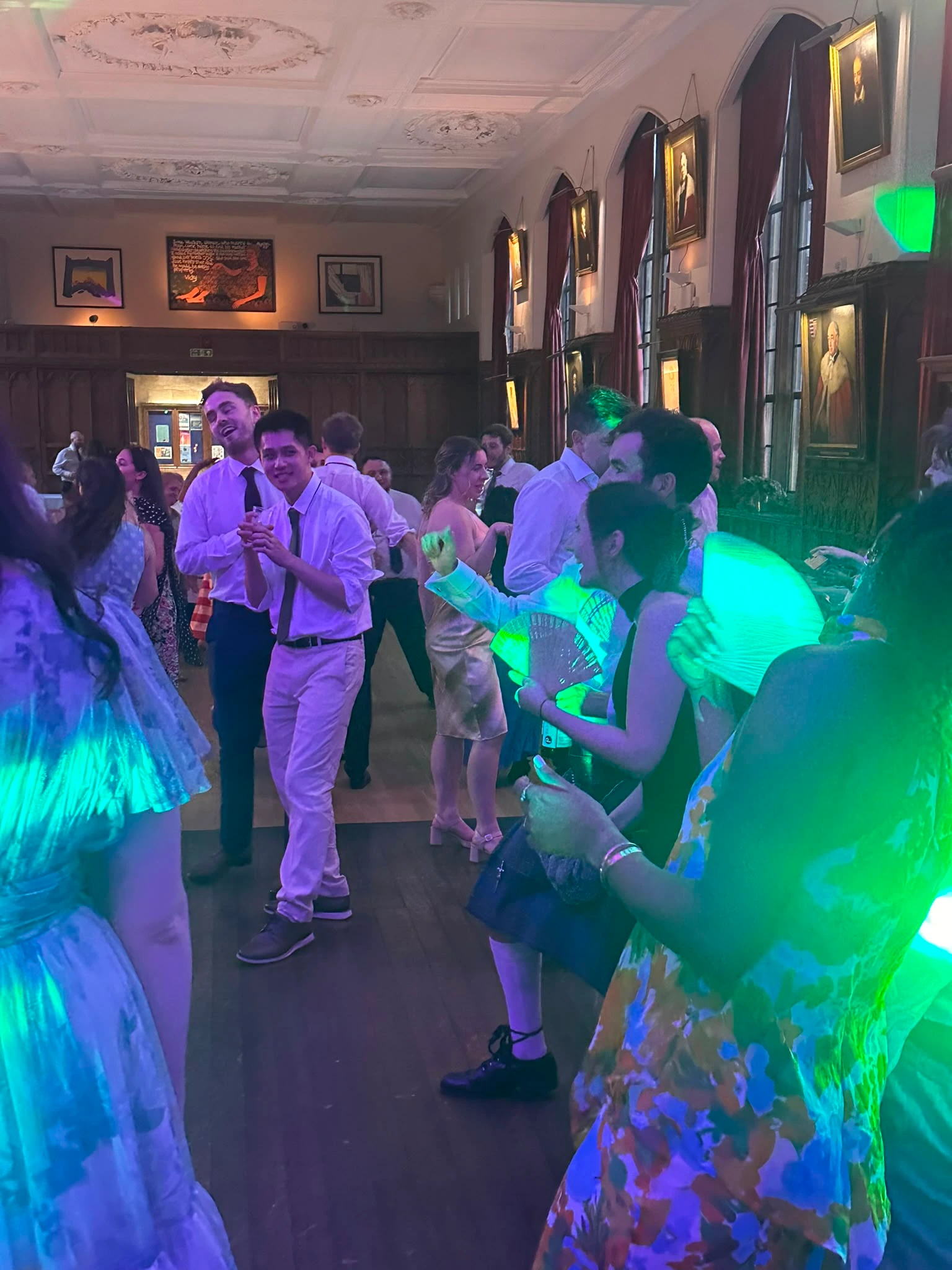 The dance floor filling under green wash lighting