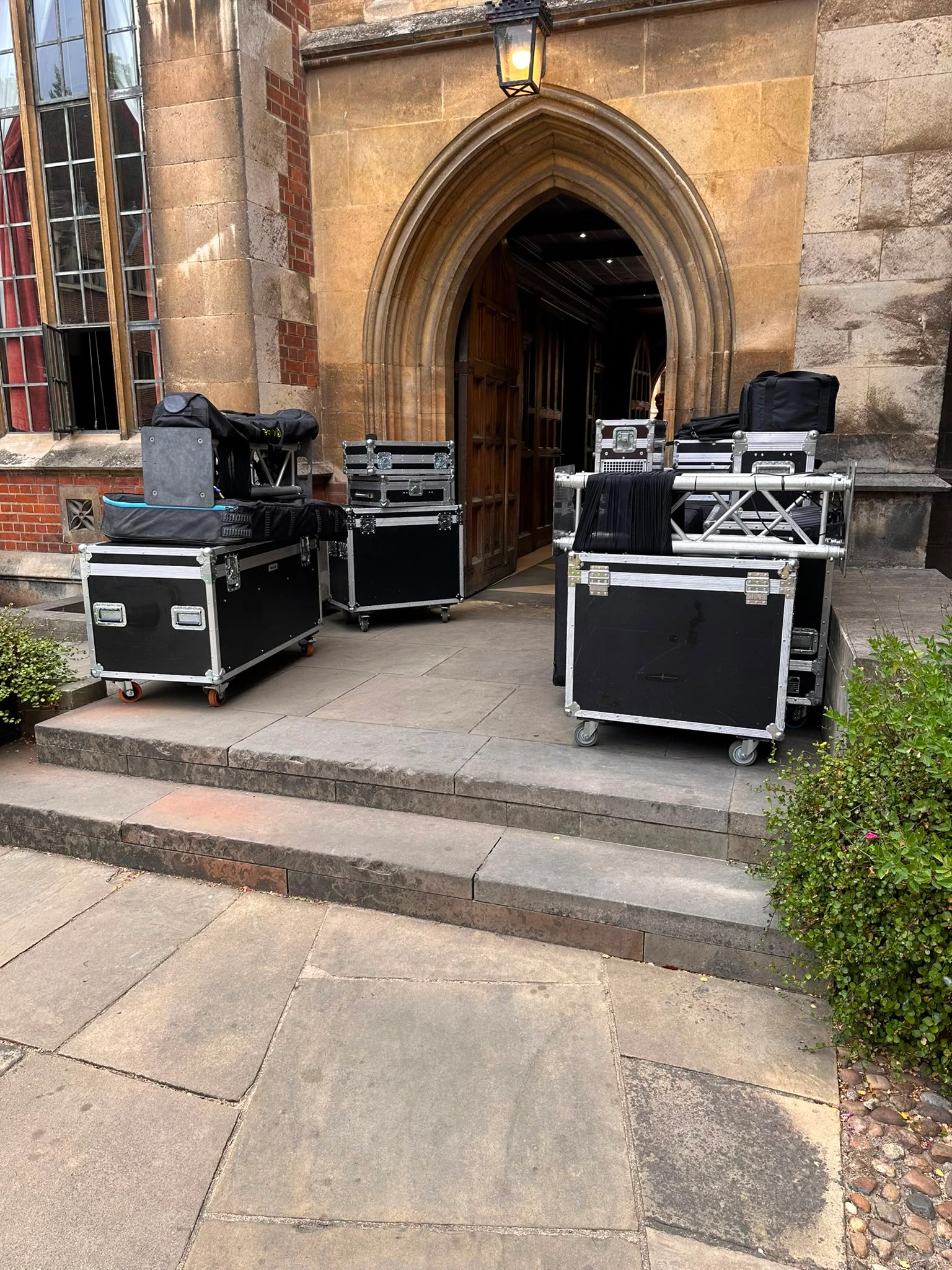 Flight cases waiting at the college's gothic doorway before the load-in