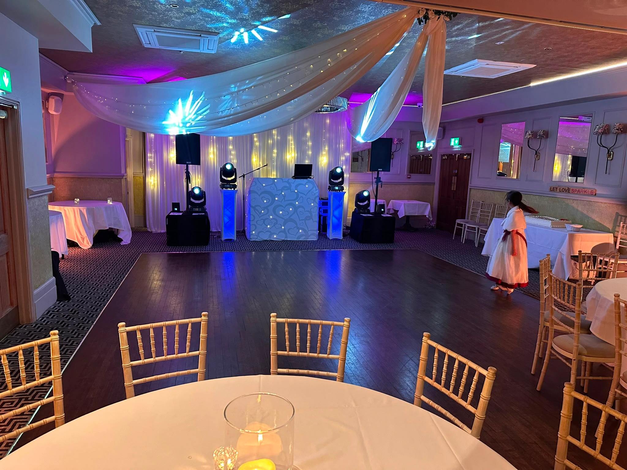 Blue booth beneath cream ceiling drapes